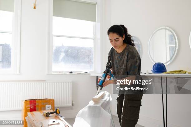 diy renovations - caulk gun stock pictures, royalty-free photos & images