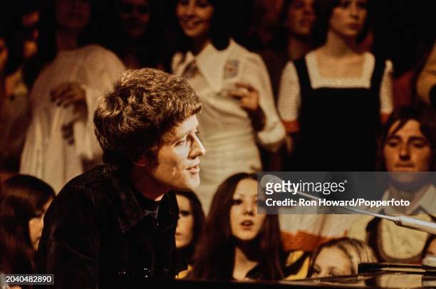 Irish singer Gilbert O'Sullivan performs in front of a studio audience on the set of a pop music television show in London circa 1970.