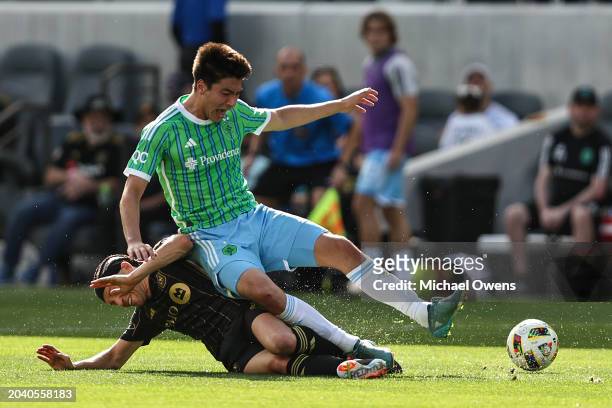 Ilie Sánchez of Los Angeles FC slide tackles Josh Atencio of Seattle Sounders during the second half of a game at BMO Stadium on February 24, 2024 in...