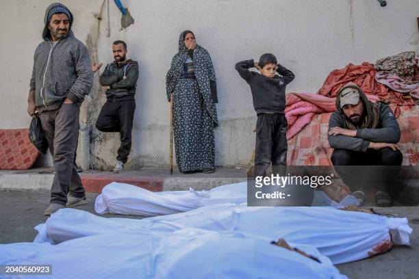 Graphic content / People mourn at Al-Shifa hospital in Gaza City, over the bodies of Palestinians killed in an early morning incident when residents...
