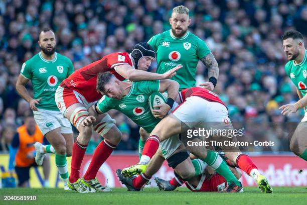 February 24: Peter O'Mahony of Ireland is tackled by Adam Beard of Wales, Alex Mann of Wales and Elliot Dee of Wales during the Ireland V Wales, Six...