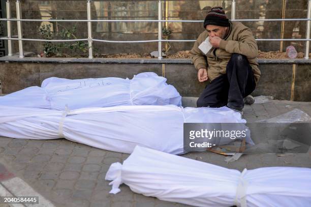 Man mourns at Al-Shifa hospital in Gaza City, over the bodies of Palestinians killed in an early morning incident when residents rushed toward aid...