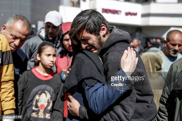 Graphic content / People mourn following an early morning incident when residents rushed toward aid trucks in Gaza City on February 29, 2024.. The...