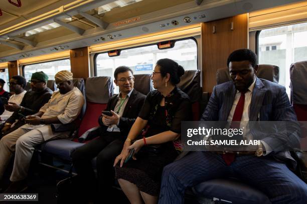 Guests and dignitaries are seen onboard the the Red Line Train at the Ikeja train station during its inaguration by the Nigerian President Bola Ahmed...