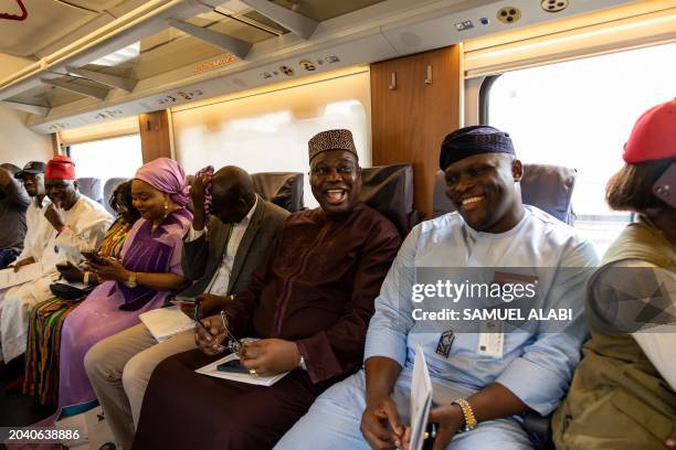 Guests and dignitaries are seen onboard the the Red Line Train at the Ikeja train station during its inaguration by the Nigerian President Bola Ahmed...