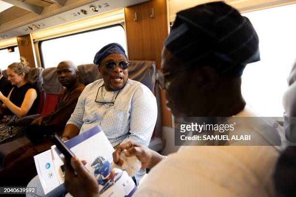 Guests and dignitaries are seen onboard the the Red Line Train at the Ikeja train station during its inaguration by the Nigerian President Bola Ahmed...