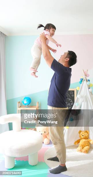 asian father hold high kid - accompanying stock pictures, royalty-free photos & images