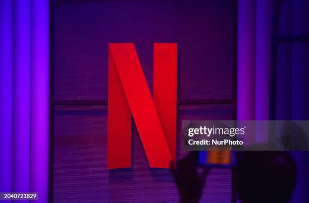 Man is clicking a mobile photograph of Netflix's ''N'' logo at an event in Mumbai, India, on February 29, 2024.