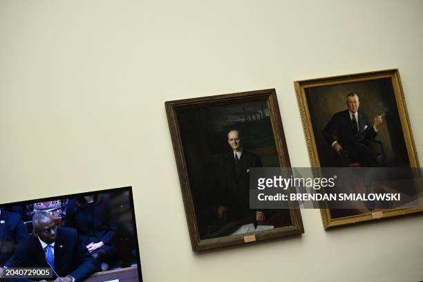 Defense Secretary Lloyd Austin is seen on a TV screen as he testifies during a House Committee on Armed Services hearing to examine the circumstances...