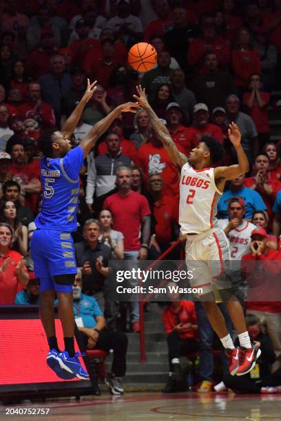 Ethan Taylor of the Air Force Falcons shoots a three-pointer against Donovan Dent of the New Mexico Lobos during the second half at The Pit on...