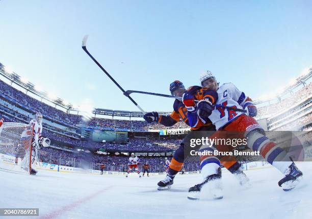 Anders Lee of the New York Islanders battles with Jacob Trouba of the New York Rangers during the 2004 Navy Federal Credit Union Stadium Series game...