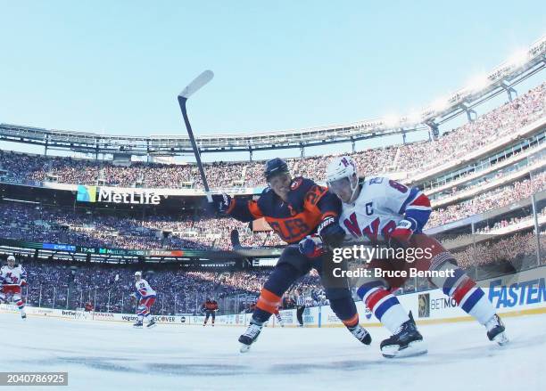 Anders Lee of the New York Islanders battles with Jacob Trouba of the New York Rangers during the 2004 Navy Federal Credit Union Stadium Series game...