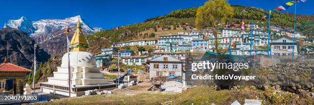 nepal namche bazaar buddhist stupa prayer flags sherpa teahouses panorama - namche bazaar stock pictures, royalty-free photos & images