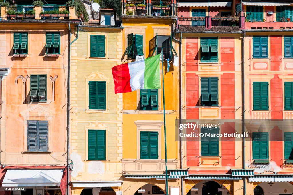 Traditional building facade with italian flag, Portofino, Italy