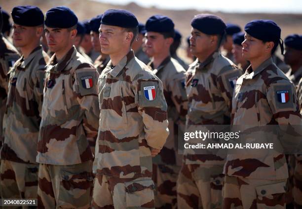 French military trainers stand at ease during the graduation ceremony of Iraq's special forces' new "desert battalion", after months of training by...