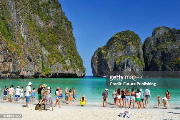 February 23 Phuket, Thailand: Tourists on Maya Bay beach in Phi Phi Archipelago located in the Andaman Sea, south of Thailand in the province of...