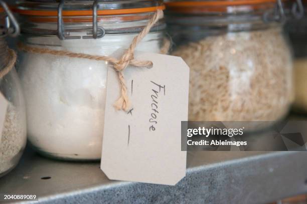 fructose powder in labelled glass jar - fructose stock pictures, royalty-free photos & images