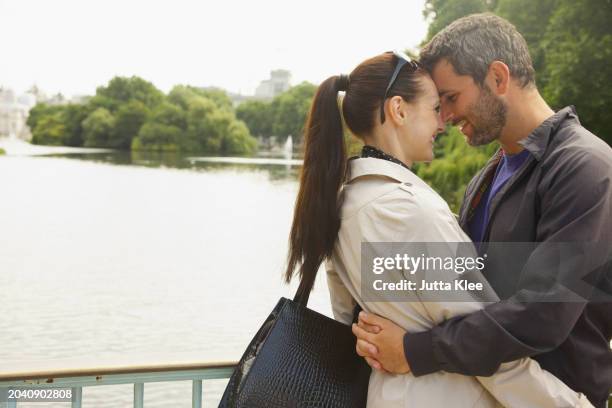 couple embracing, st. james's park lake, london, england - passion stock pictures, royalty-free photos & images