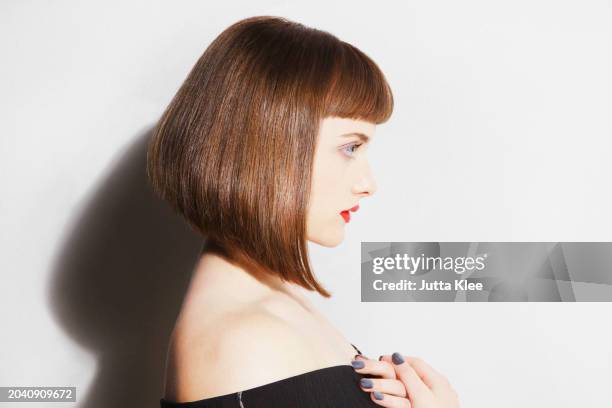 profile of young woman with bobbed hair - bobbed hair stock pictures, royalty-free photos & images