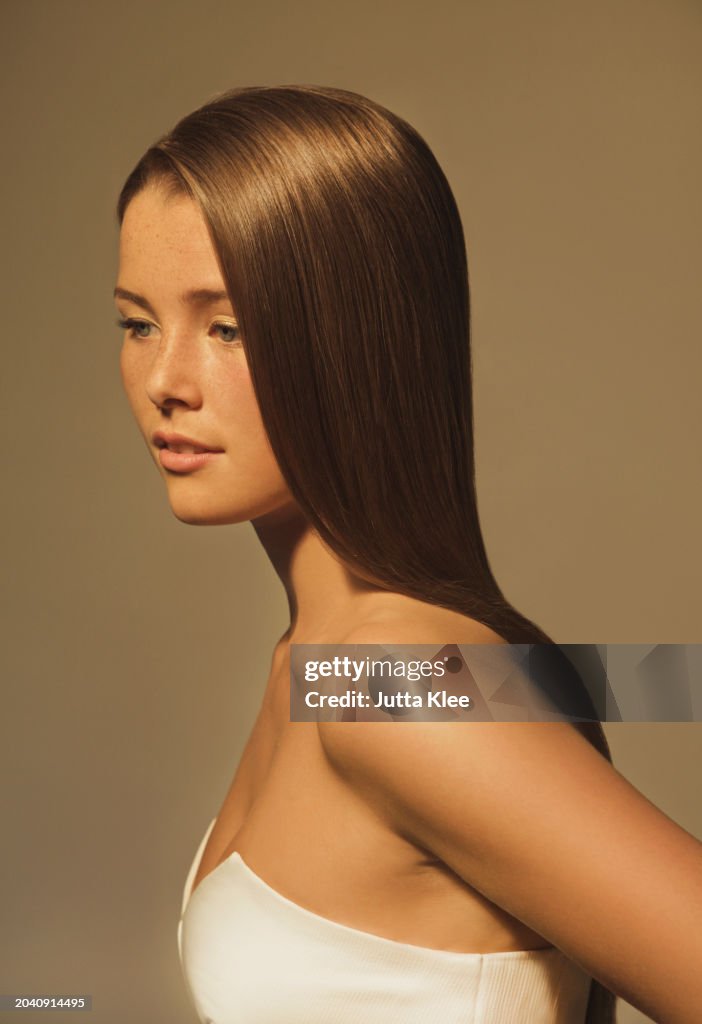 Side View of Young Woman with Glossy Straight Hair