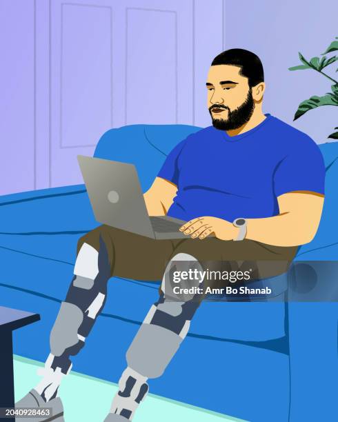 man with prosthetic legs working from home at laptop on living room sofa - amputee stock illustrations