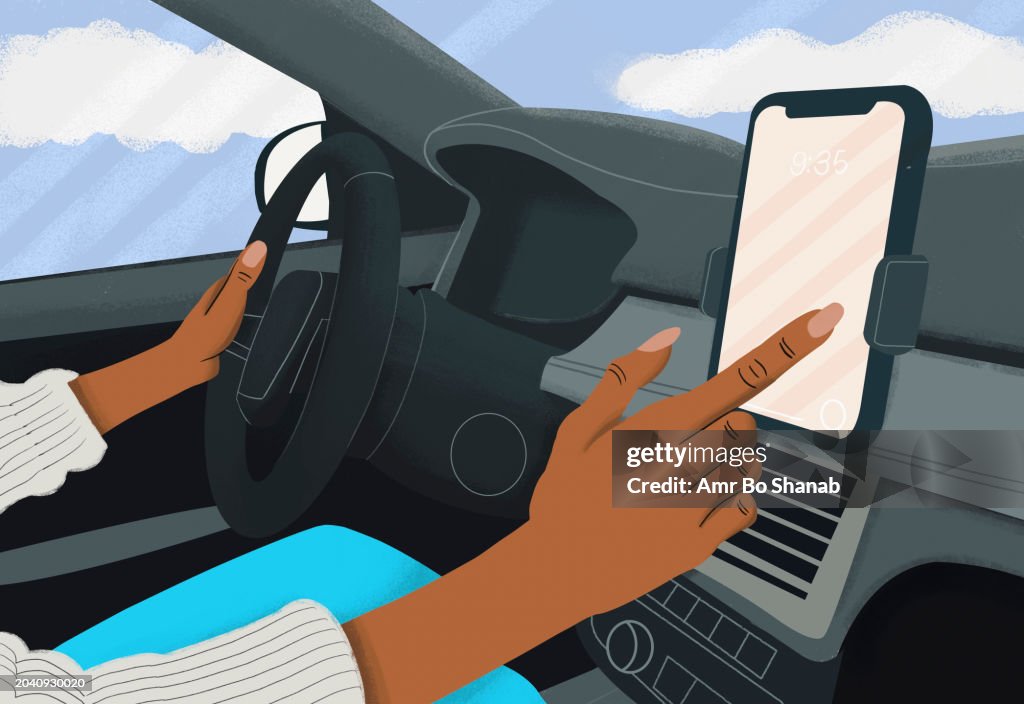 Close up woman driving and using touch screen smart phone in car