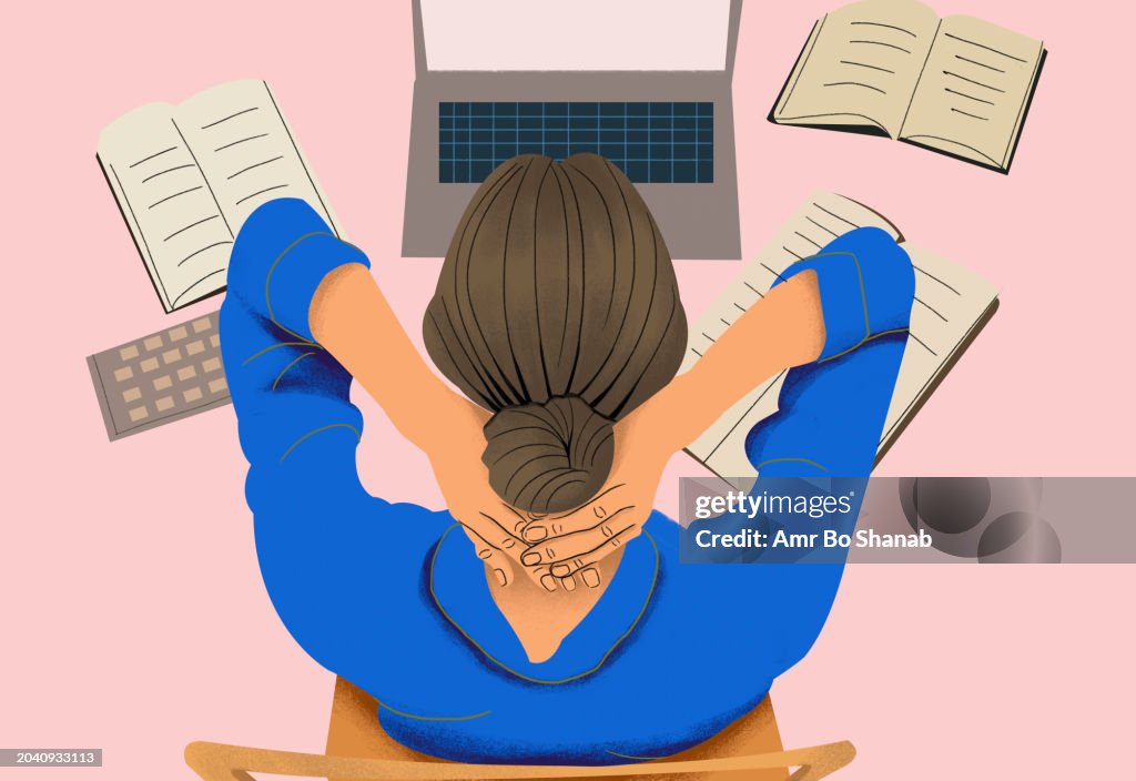High angle view businesswoman working at laptop with hands behind head