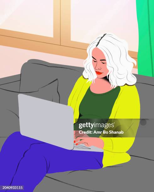 woman with white hair working from home at laptop on living room sofa - computer software stock illustrations