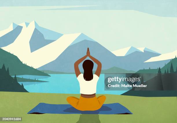 serene woman meditating on yoga mat in grass overlooking idyllic, scenic mountain and lake - lotus position stock illustrations