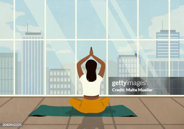 woman practicing yoga meditation at window with cityscape view - lotus stock illustrations