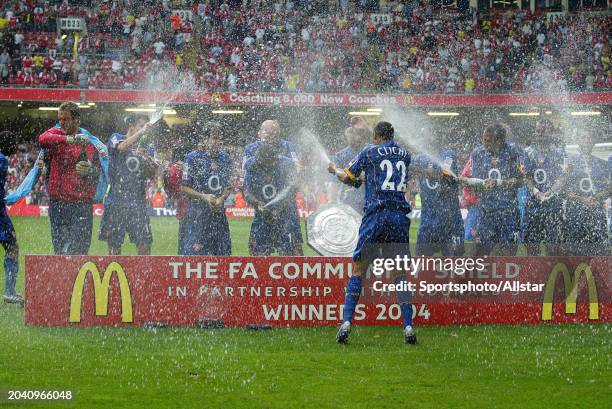 Arsenal Team Celebrate with Gael Clichy spraying Champagne after winning the FA Community Shield match between Arsenal and Manchester United at...
