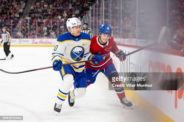 Henri Jokiharju of the Buffalo Sabres skates against Cole Caufield of the Montreal Canadiens during the first period of the NHL regular season game...