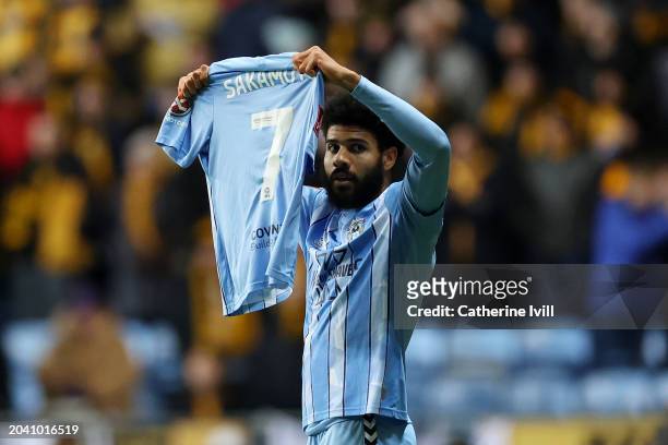 Ellis Simms of Coventry City celebrates scoring his team's first goal whilst holding the shirtt of injured team mate Tatsuhiro Sakamoto during the...