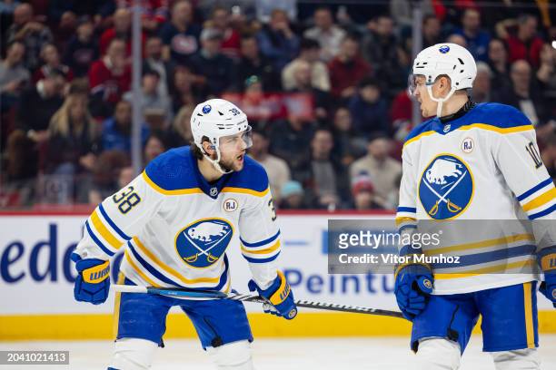 Kale Clague and Henri Jokiharju of the Buffalo Sabres talk during the first period of the NHL regular season game against the Montreal Canadiens at...