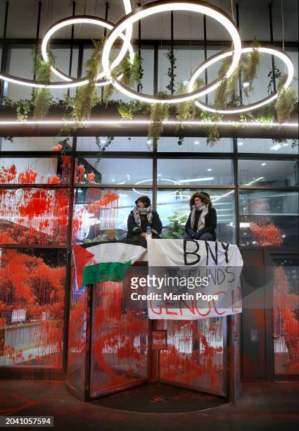 The outside of number 1 Piccadilly Gardens is covered in red paint and two protesters from Palestine Action occupy the roof of the revolving entrance...