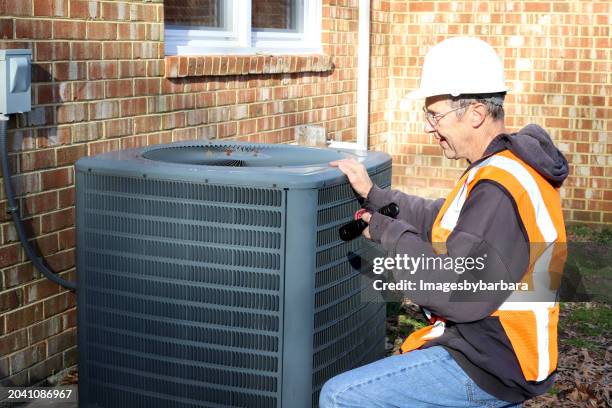 home inspection of central air unit by a maintenance worker - broken air conditioner stock pictures, royalty-free photos & images