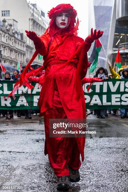 Extinction Rebellion's Red Rebels join climate and human rights activists marching to the offices of AXA UK plc to protest against the insurer's...