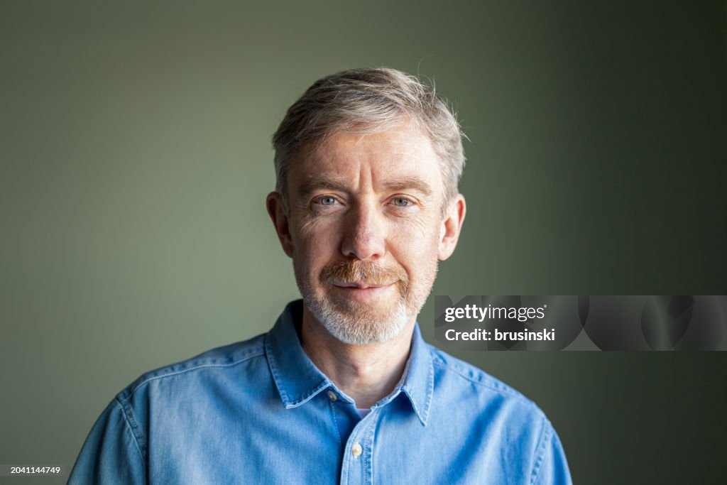 Close up indoors portrait of a happy 50 year old man