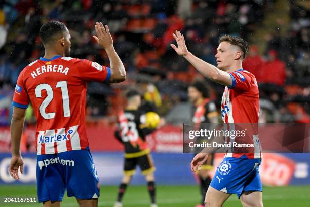 Viktor Tsygankov of Girona celebrates scoring the opening goal with team mate Yangel Herrera during the LaLiga EA Sports match between Girona FC and...
