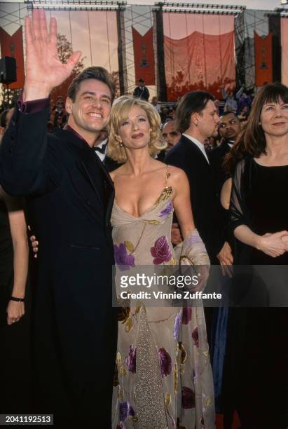Actors Jim Carrey and Lauren Holly on the red carpet at the 69th Annual Academy Awards in Los Angeles, US, 24th March 1997.