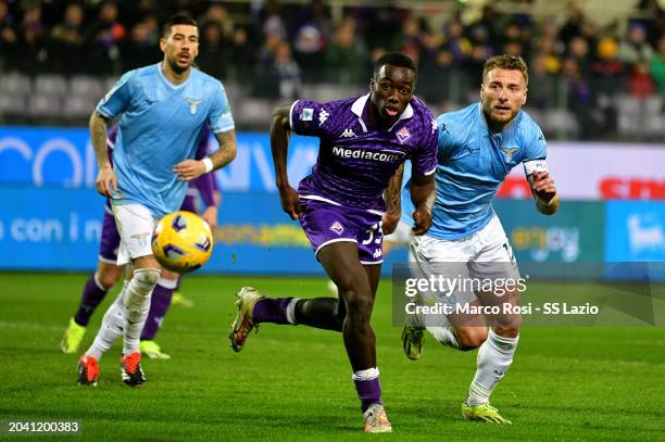 Ciro Immobile of SS Lazio compete for the ball with Michael Kayode ACF Fiorentina during the Serie A TIM match between ACF Fiorentina and SS Lazio at...