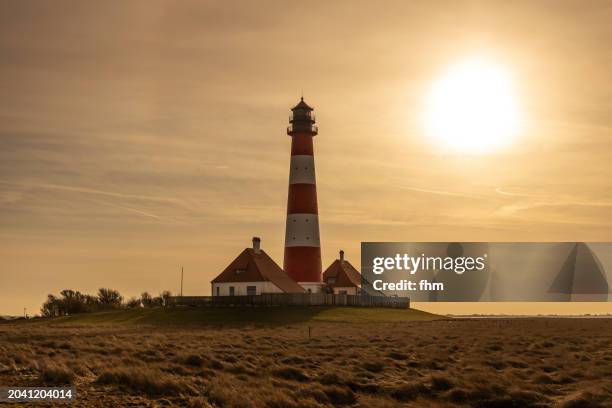 travel destination: westerhever lighthouse at sunset (schleswig-holstein, germany) - lower saxony stock pictures, royalty-free photos & images