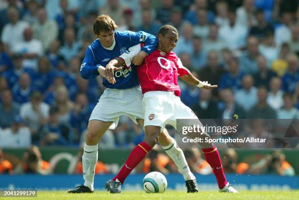 Gilberto Silva of Arsenal and Kevin Kilbane of Everton challenge during the Premier League match between Everton and Arsenal at Goodison Park on...