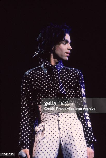 American singer and songwriter Prince performs in concert, wearing a black and white polka-dot outfit, Philadelphia, Pennsylvania, October 18, 1988.