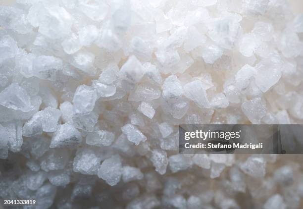 sea salt grains - saliera foto e immagini stock