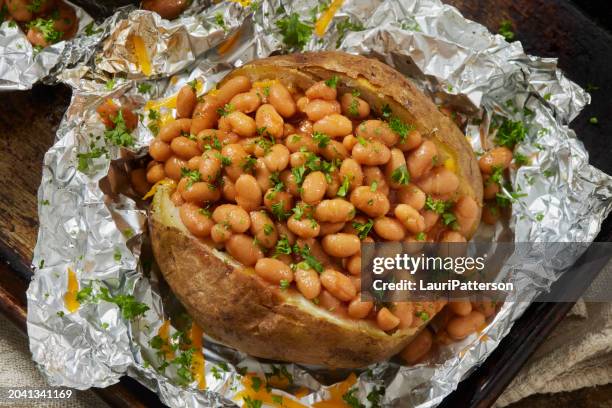 jacket potatoes with baked beans - baked stuffed potato stock pictures, royalty-free photos & images