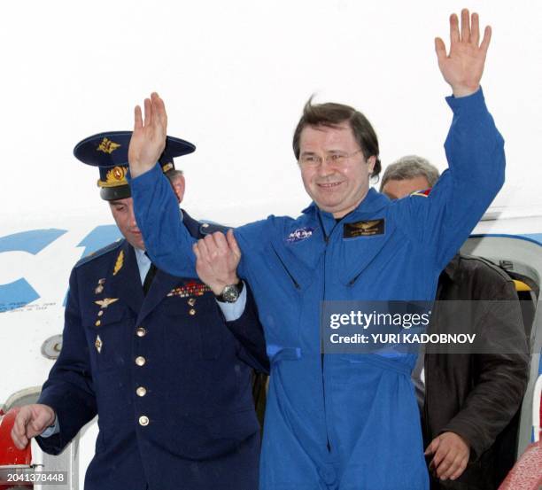 Russian cosmonaut Nikolai Budarin raises his hands as he arrives in Star city outside Moscow, 04 May 2003. The Soyuz TMA-1 vessel carrying cosmonaut...