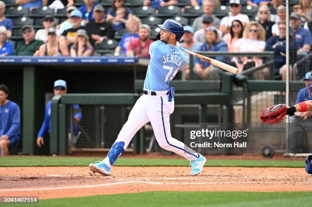 Carter Jensen of the Kansas City Royals hits an RBI double against the Chicago Cubs during the second inning of a spring training game at Surprise...