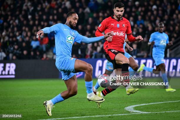 Le Puy's French defender Anthony Civet fights for the ball with Rennes' French forward Martin Terrier during the French Cup quarter-final football...