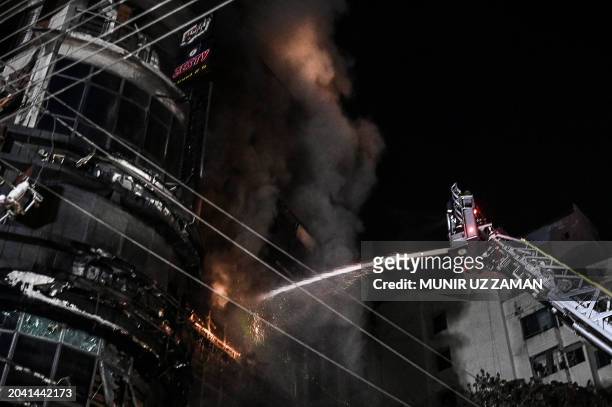 Firefighters work to extinguish a fire in a commercial building that killed at least 43 people, in Dhaka, on February 29, 2024. At least 43 people...